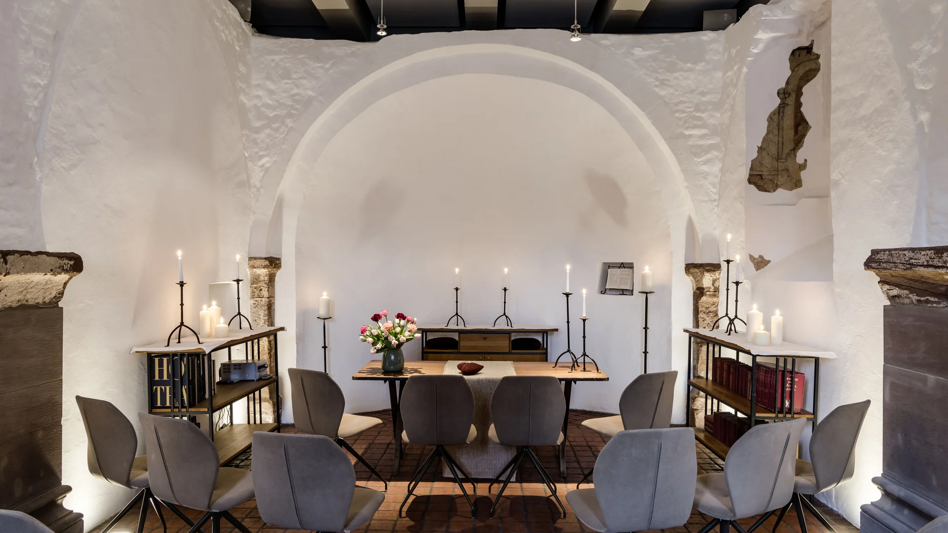 Our venue, your dream wedding Small quiet room with chairs, candles, and a table with flowers