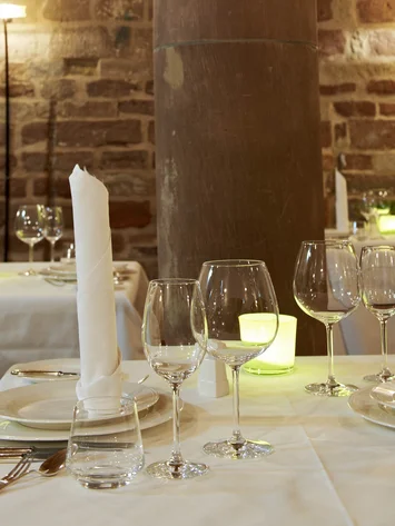 Our venue, your dream wedding Elegant restaurant with set tables and stone pillar inside the room