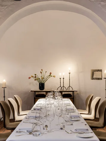 Our venue, your dream wedding Elegant dining table set in historic room decorated with candles and flowers