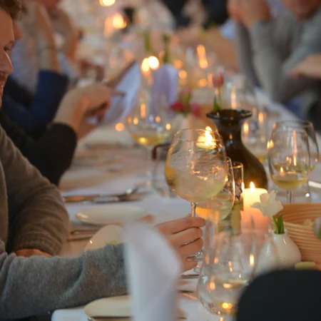 Veranstaltungen im Kloster Hornbach Menschen sitzen an einem langen Tisch mit wein und Kerzenlicht