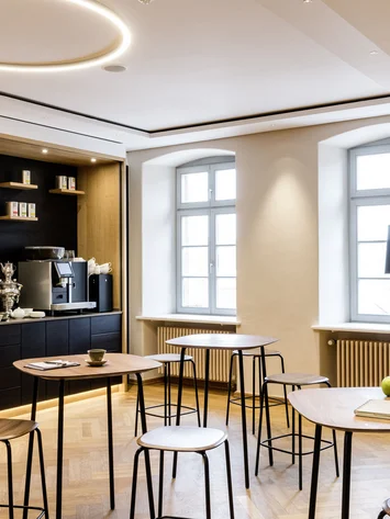 Tagungsräume Pfalz | Historische & moderne Räume im Kloster Hornbach Modern eingerichteter Aufenthaltsraum mit Stehtischen, Kaffeemaschine und Dekoration