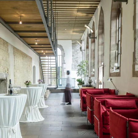 Veranstaltungen im Kloster Hornbach Moderne Lounge mit roten Sofas und Stehtischen in historischem Gebäude
