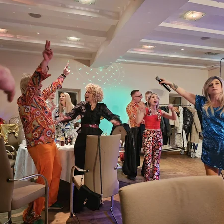 Veranstaltungen im Kloster Hornbach Menschen feiern und singen mit Mikrofon auf einer Party in bunten Outfits