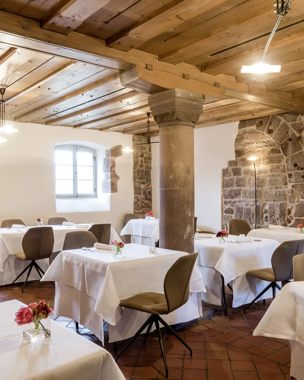 Von gemütlich bis Gourmet: Restaurants im Kloster Hornbach Elegantes Restaurant mit weißen Tischdecken, Holzbalkendecke und Steinmauern